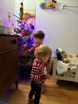 Children Dancing by Christmas Tree in Striped Pajamas