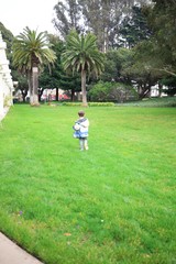 Child Explores Park Grounds on Overcast Day