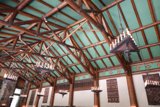 Majestic Chandeliers Hang from a Vaulted Wooden Ceiling
