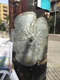 Metal Flower on a Roadside Pole