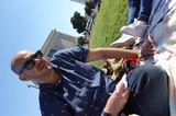 Man Relaxing at Outdoor Gathering in Park