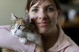 Woman and Calico Cat Share a Tender Moment