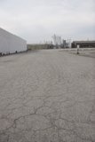 Abandoned Parking Lot with Factory Views