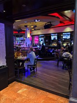 Modern Sports Bar Interior with Vibrant Red Accent Lighting