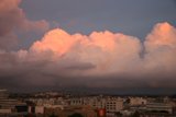 Cityscape under dramatic cumulus clouds