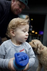 Toddler with Curly Hair Playing with Blue Toy