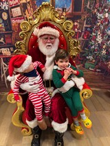 Two Children Visit Santa in His Workshop Throne