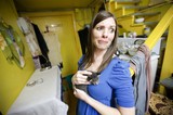 Woman Holds Tiny Kitten with Apprehensive Expression