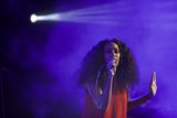 Solange Singing Hand Palm Out Spotlight Beam Purple Haze