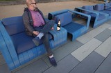 Man Relaxing with Champagne on Blue Furniture