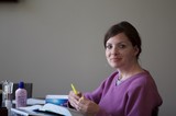 Woman Studying with Yellow Pen at Desk