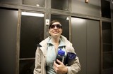 Woman With Water Bottle Smiles Near Lockers