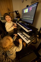 Young Brothers Making Music in Home Recording Studio