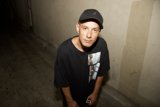 Portrait of Dj S wearing a black T-shirt and baseball cap