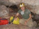 Cave Explorer Navigating Tight Underground Passage