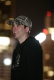 Smiling Man in Baseball Cap and Hoodie