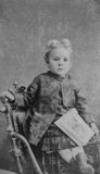 Vintage Portrait of Young Boy Sitting on Chair