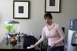 Woman Tidying Up a Modern Home Interior
