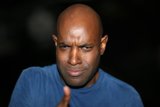 Bald Man Gesturing in Blue