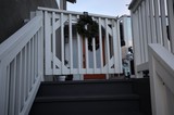 Child on Winter Deck with Holiday Wreath