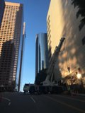 Construction Crane Lifting Equipment onto Office Building in Urban Metropolis