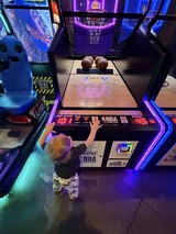 Young Child Playing NBA Arcade Basketball Game