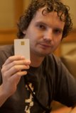 Black Shirted Man Using Mobile Phone