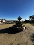 Serene Cityscape from a Park Fountain