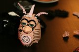 Horned plushie in a wooden setting