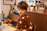 Young Boy Enjoying Christmas Dinner at Home
