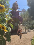 Woman and Dog Pose in Front of Giant Park Sculpture