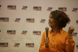 Woman Holds Mic at Political Event
