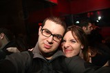 Friends Pose Together at Dimly Lit Night Venue