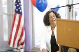 Woman with Balloons at Podium