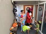 Family Halloween Trick-or-Treating at Front Door