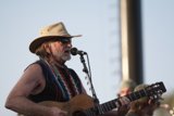 Willie Nelson strums the guitar at Coachella