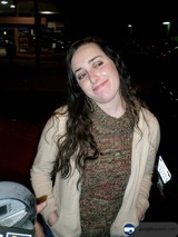 Smiling Woman Poses with Her Car