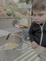 Young Child Enjoying Outdoor Meal on Patio