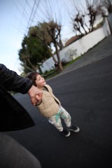 Parent and Child Walking Hand in Hand at Dusk
