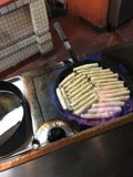 Hot Dogs sizzling on a Cooking Pan