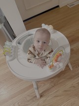 Baby in White Activity Seat with Toys