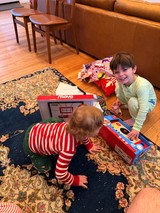 Brothers Playing with Toy Cash Register on Living Room Floor
