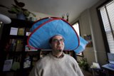 The Hat-Wearing Man at His Desk