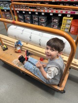 Young Boy's Hardware Store Cart Adventure