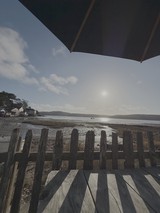 Coastal View Through Weathered Wooden Fence