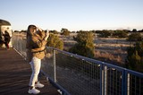 Woman Photographing Sunset at Desert Overlook