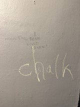 Hand-Drawn Graffiti Message on Textured Wall