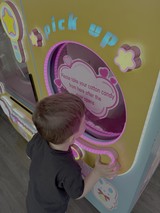 Child Using Interactive Cotton Candy Dispenser