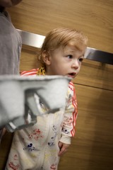 Curious Toddler in Mickey Mouse Pajamas at Home