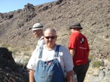 Man in Overalls Surveying Hillside